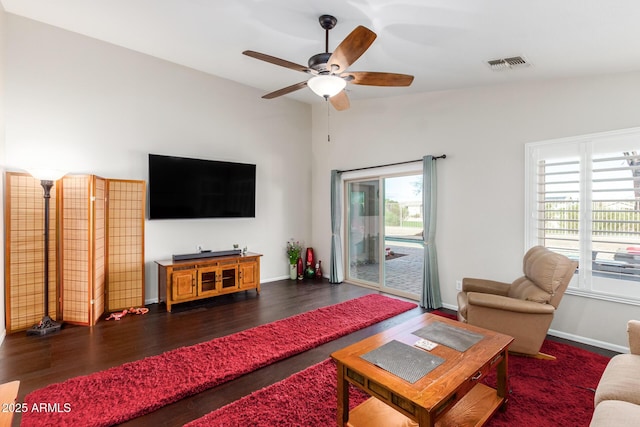 living room with vaulted ceiling, dark hardwood / wood-style floors, and ceiling fan