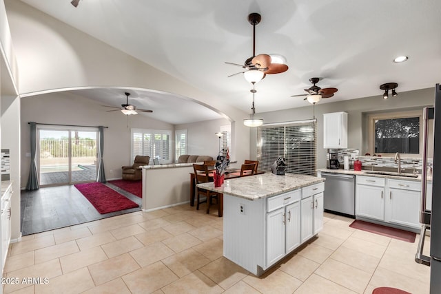 kitchen with sink, a center island, stainless steel dishwasher, and white cabinets