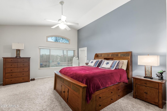 carpeted bedroom with ceiling fan and high vaulted ceiling