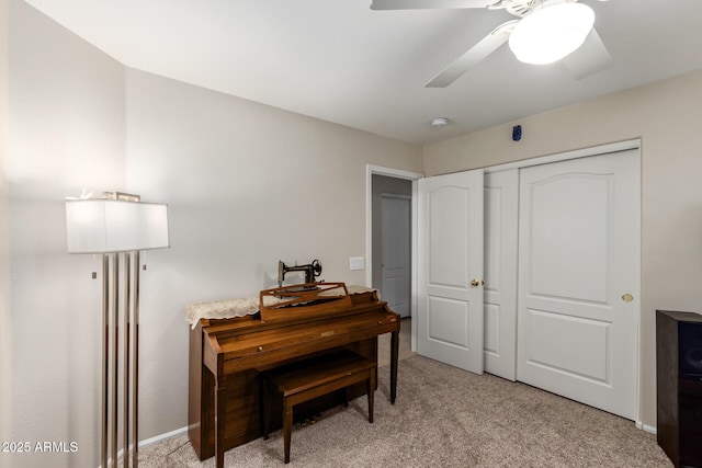 misc room featuring ceiling fan and light colored carpet