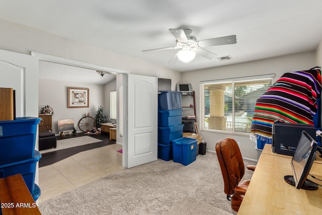 home office featuring light tile patterned floors and ceiling fan