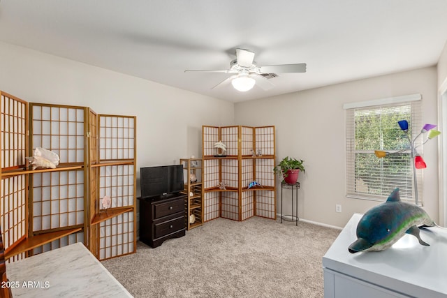 interior space featuring ceiling fan and light carpet