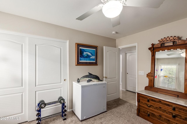 clothes washing area with ceiling fan and light colored carpet