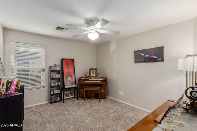 misc room with light colored carpet and ceiling fan