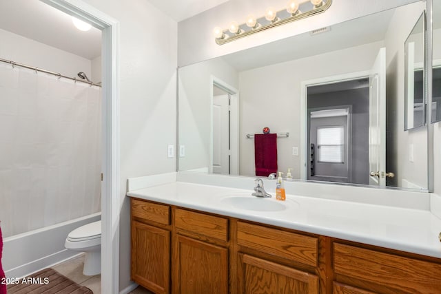 full bathroom featuring vanity, shower / tub combo, tile patterned floors, and toilet