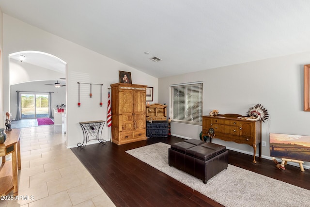 living area featuring lofted ceiling, ceiling fan, and light wood-type flooring