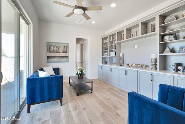 living room featuring ceiling fan and light wood-type flooring