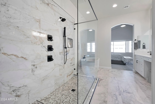 bathroom featuring vanity and tiled shower