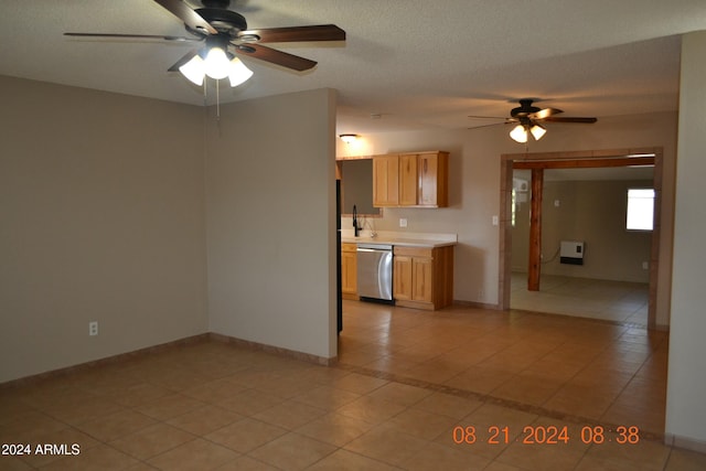 kitchen with a textured ceiling, stainless steel dishwasher, ceiling fan, and light tile patterned flooring