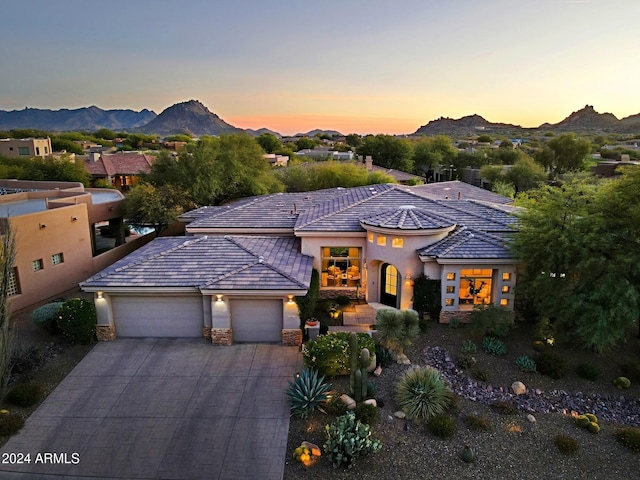 view of front of house with a mountain view and a garage