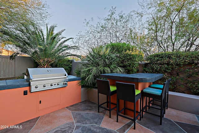 view of patio / terrace featuring a grill and an outdoor bar