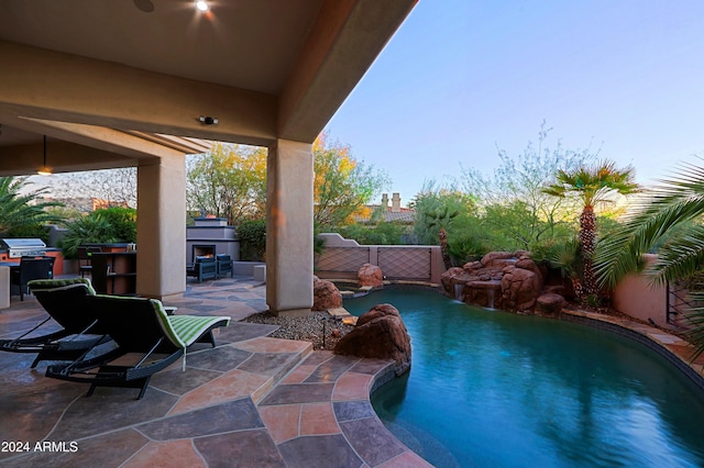 exterior space featuring pool water feature, exterior fireplace, and a patio area