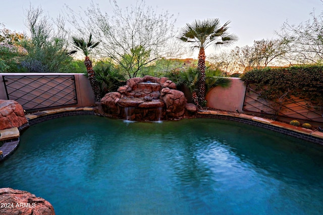 view of pool with pool water feature