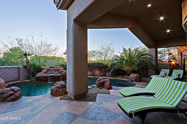 view of patio terrace at dusk