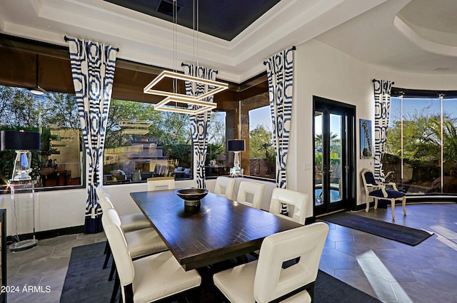 dining room with french doors and a tray ceiling