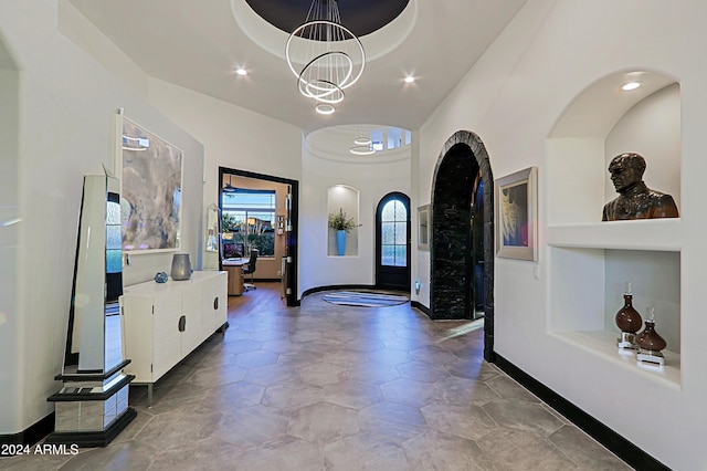 entrance foyer with a towering ceiling and an inviting chandelier