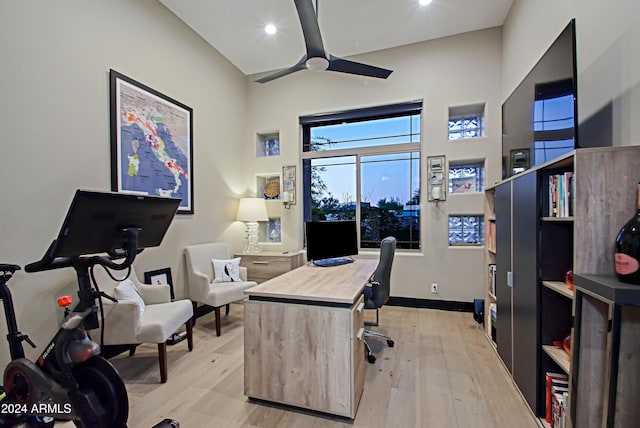 home office with ceiling fan and light hardwood / wood-style floors