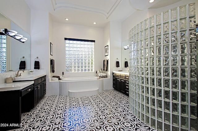 bathroom featuring a washtub and vanity