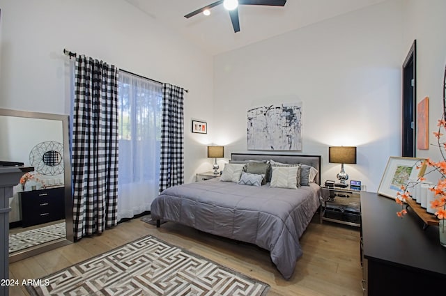 bedroom featuring ceiling fan, light hardwood / wood-style flooring, and vaulted ceiling