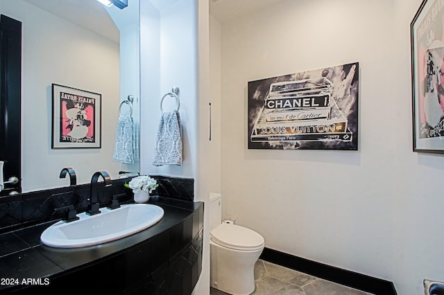 bathroom featuring tile patterned flooring, vanity, and toilet