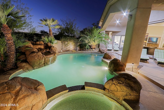 view of swimming pool with a patio and a hot tub