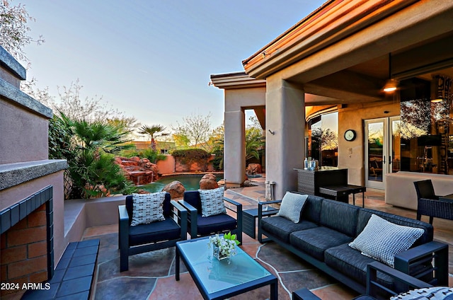 view of patio featuring an outdoor living space with a fireplace