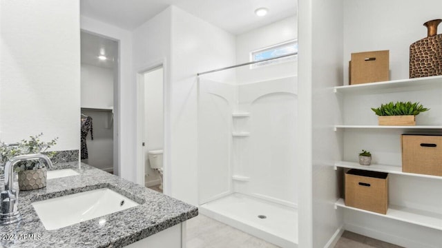 38100 W Bello Ln, Maricopa, AZ 85138 - bathroom with a shower stall, double vanity, and toilet