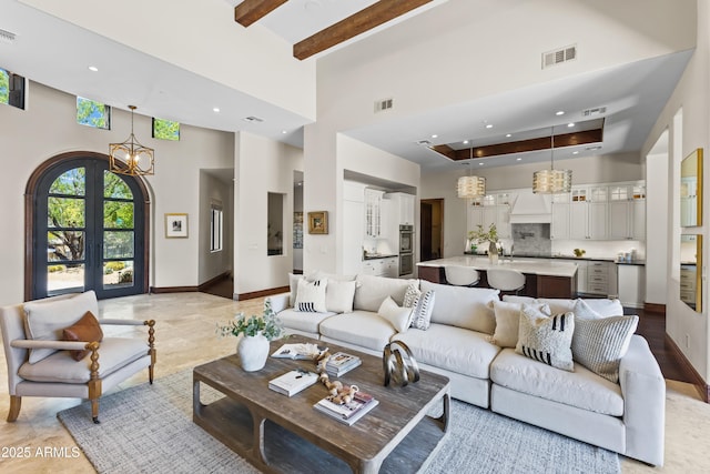 37334 N Winding Wash Trl, Carefree, AZ 85377 - living room with a chandelier, visible vents, french doors, and a towering ceiling