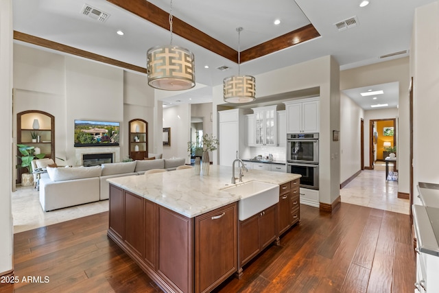 37334 N Winding Wash Trl, Carefree, AZ 85377 - kitchen featuring stainless steel double oven, a sink, visible vents, and dark wood-type flooring
