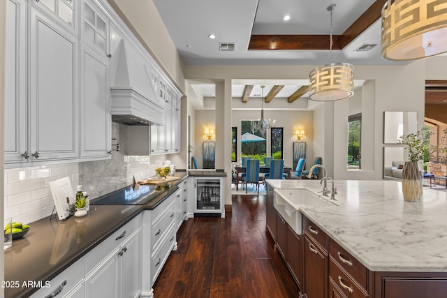 37334 N Winding Wash Trl, Carefree, AZ 85377 - kitchen featuring a sink, black electric cooktop, beverage cooler, dark wood finished floors, and decorative backsplash