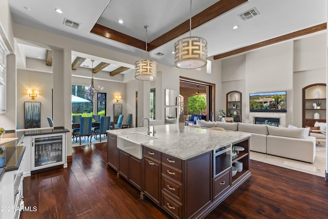 37334 N Winding Wash Trl, Carefree, AZ 85377 - kitchen featuring beverage cooler, a sink, visible vents, and beamed ceiling