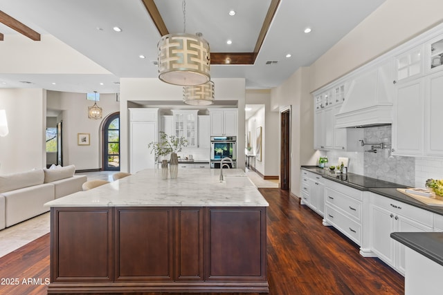 37334 N Winding Wash Trl, Carefree, AZ 85377 - kitchen featuring decorative backsplash, custom exhaust hood, black electric stovetop, and open floor plan