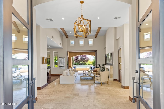 37334 N Winding Wash Trl, Carefree, AZ 85377 - foyer entrance with visible vents, baseboards, a high ceiling, and a notable chandelier