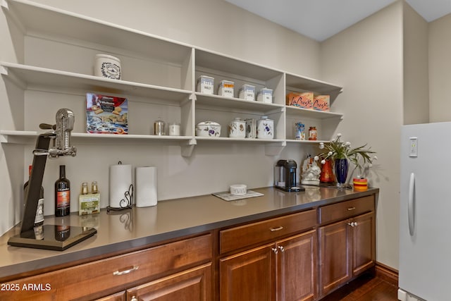 37334 N Winding Wash Trl, Carefree, AZ 85377 - bar featuring freestanding refrigerator, baseboards, and dark wood-type flooring