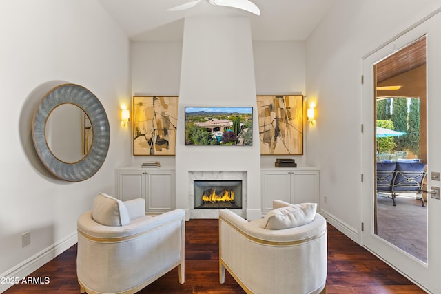 37334 N Winding Wash Trl, Carefree, AZ 85377 - living room featuring baseboards, ceiling fan, a fireplace, and dark wood-type flooring