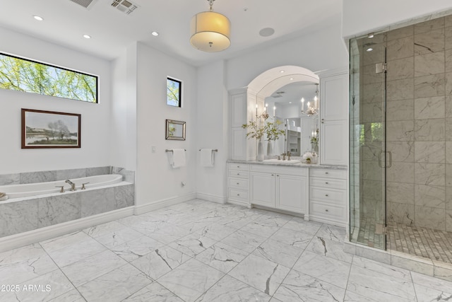 37334 N Winding Wash Trl, Carefree, AZ 85377 - bathroom with visible vents, a garden tub, marble finish floor, vanity, and a stall shower