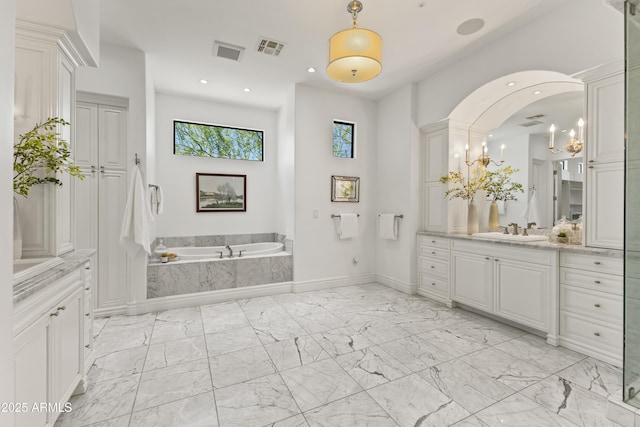 37334 N Winding Wash Trl, Carefree, AZ 85377 - bathroom featuring marble finish floor, visible vents, a garden tub, and vanity