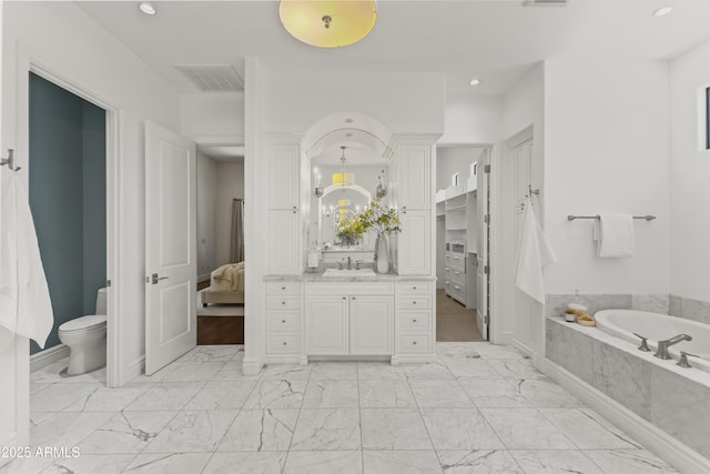 37334 N Winding Wash Trl, Carefree, AZ 85377 - bathroom with vanity, toilet, ensuite bathroom, visible vents, and a garden tub