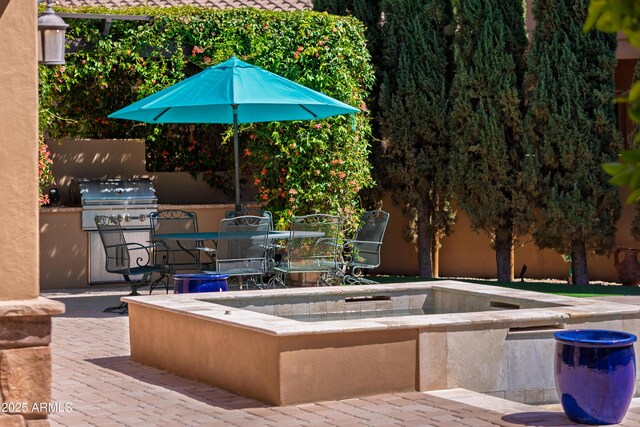37334 N Winding Wash Trl, Carefree, AZ 85377 - exterior space with outdoor dining space, a jacuzzi, exterior kitchen, and a patio area