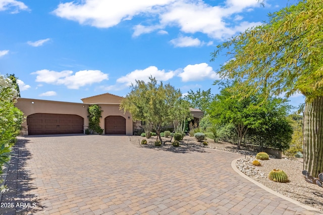 37334 N Winding Wash Trl, Carefree, AZ 85377 - view of front facade featuring decorative driveway, an attached garage, and stucco siding