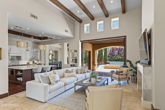 37334 N Winding Wash Trl, Carefree, AZ 85377 - living room featuring visible vents, beam ceiling, and a towering ceiling