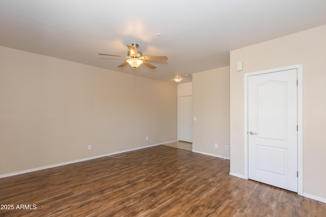 spare room with baseboards, a ceiling fan, and wood finished floors