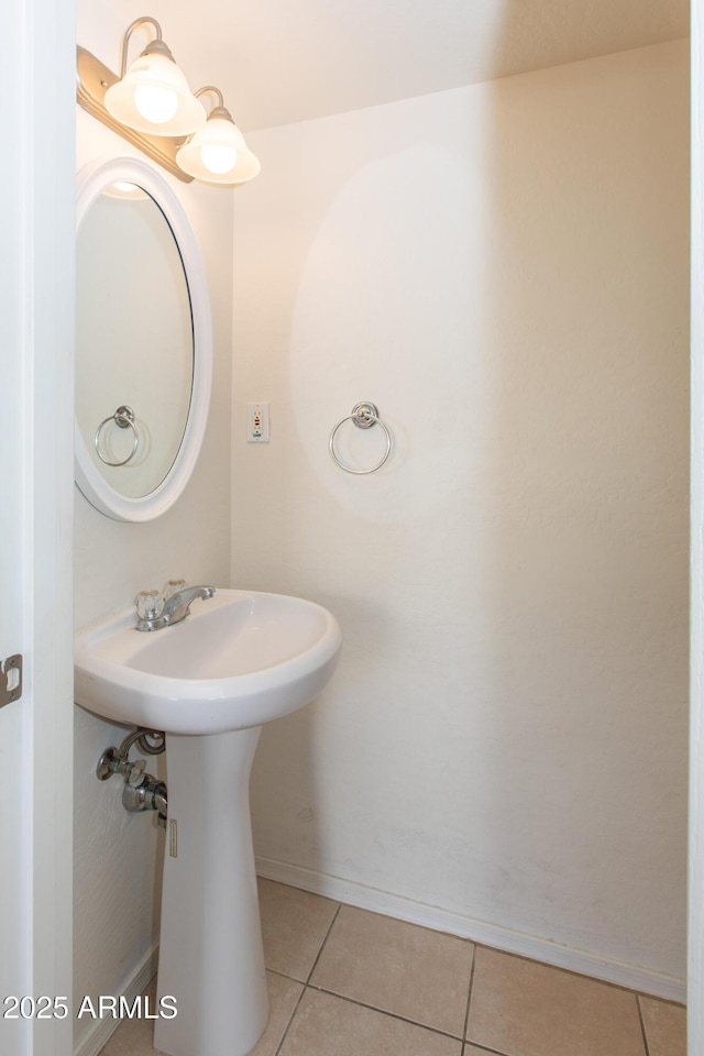 bathroom featuring baseboards and tile patterned flooring