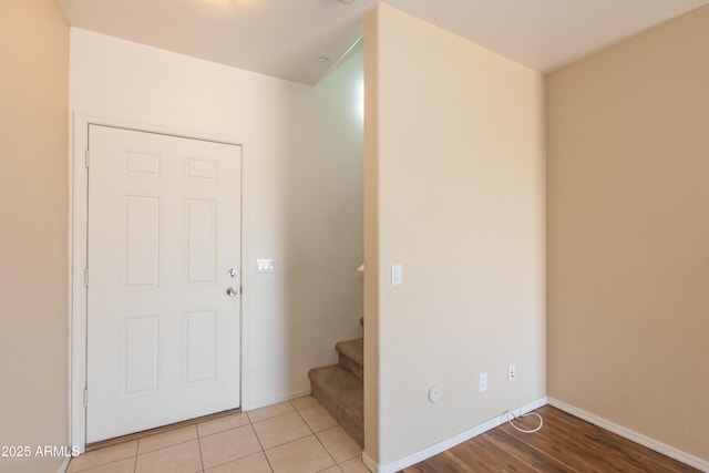 entryway featuring stairs and baseboards