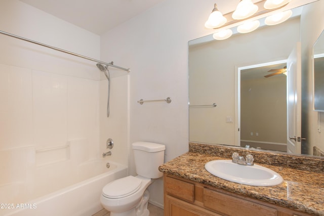 bathroom with vanity, baseboards, washtub / shower combination, and toilet