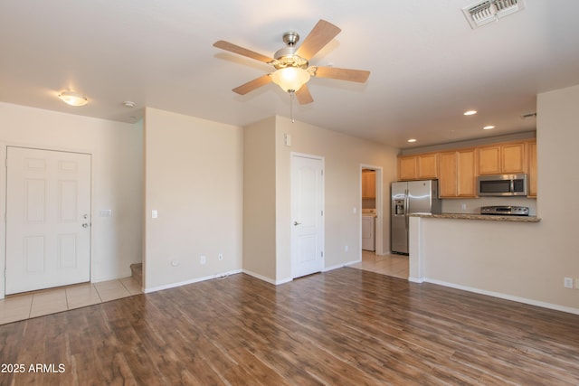 unfurnished living room featuring visible vents, washer / dryer, wood finished floors, ceiling fan, and recessed lighting