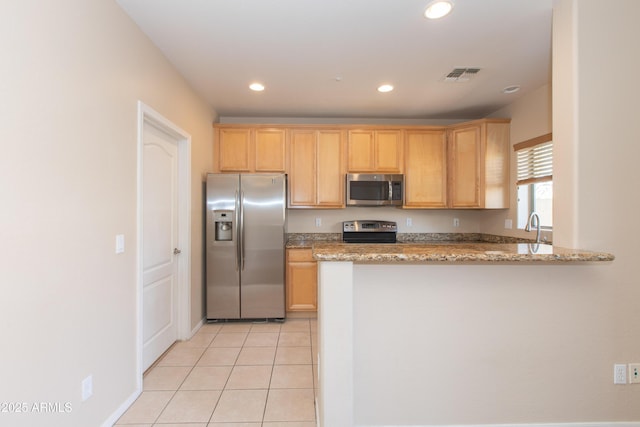 kitchen featuring light stone countertops, stainless steel appliances, recessed lighting, a peninsula, and visible vents
