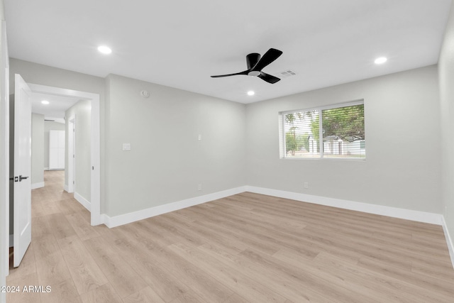 spare room with light wood-type flooring and ceiling fan