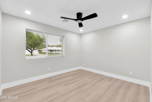 spare room with light hardwood / wood-style floors and ceiling fan