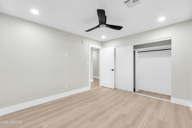 unfurnished bedroom featuring ceiling fan, a closet, and light hardwood / wood-style flooring